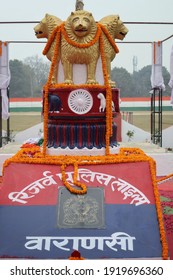 Varanasi,Uttar Prades,India-Jan 26 2021: Close Up Shot Of Indian National Emblem And Golden Loin Capital With Garland On The Occasion Of Republic Day With Selective Focus. Varanasi Police Reserve.