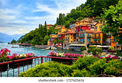 Varenna, Italy. Picturesque town at lake Como. Colourful motley Mediterranean houses at stone beach coastline among green trees. Popular health resort and touristic location. Summer day landscape. - Shutterstock ID 1727625616