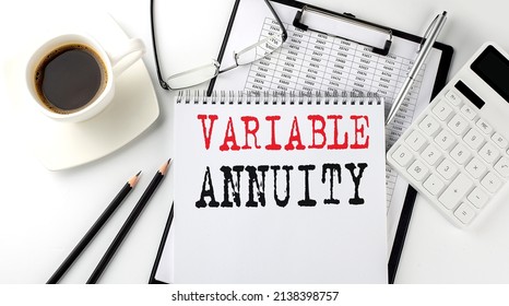 VARIABLE ANNUITY Text On Paper With Calculator, Notepad, Coffee ,pen With Graph