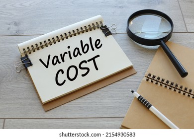 VARIABLE COST open notebook with text on the table
