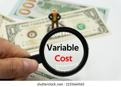Variable Cost.Magnifying glass showing the words.Background of banknotes and coins.basic concepts of finance.Business theme.Financial terms.