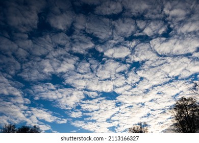 Variable Sky And Meteorology Concept. Changing Weather Background. White Little Clouds Covering The Sky.