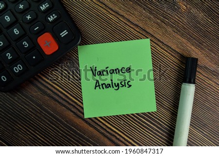 Variance Analysis write on sticky notes isolated on Wooden Table.