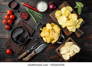 Variation different potato chips set, on old dark wooden table, top view flat lay