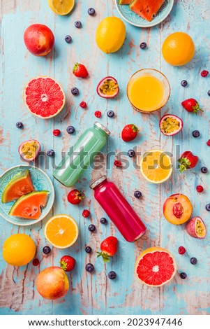 Variation of smoothies and refreshing drinks with fresh fruits for hot summer on blue background