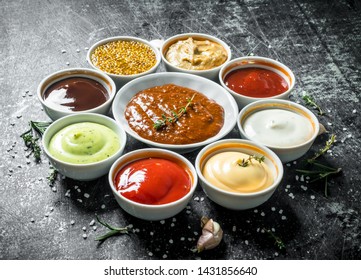 Variations of different types of sauces. On dark rustic background