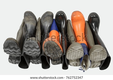 Variations of rubber boots are lined up in the zipper process.