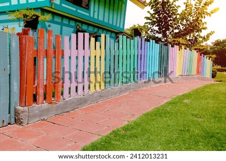 Varicolored wooden fence with walkway in garden,wood pattern