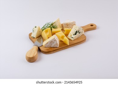 Varieties of cheese on a cheese-board isolated on a white background - Powered by Shutterstock