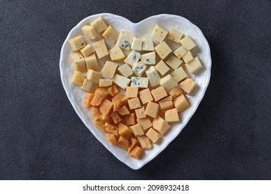 Varieties of elite cheese in a heart-shaped plate for Valentine's Day on gray background, Top view - Powered by Shutterstock