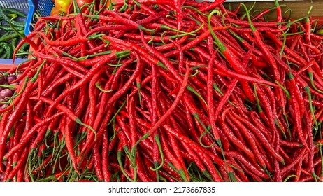 Varieties of fresh chili piled up in baskets at the market. Red Chili, Green Chili, Red Chili. food background.