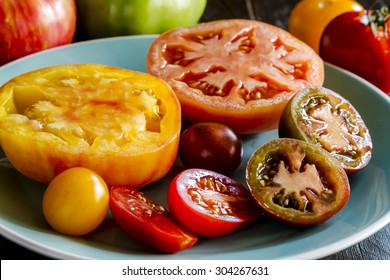 Varieties Of Sliced Heirloom Tomatoes Sitting On Light Blue Plate