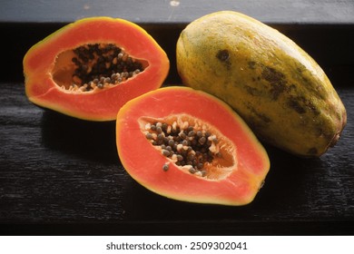 Varieties of tropical fruit, ripe Hawaiian papaya or Solo papaya on a wooden bar table 