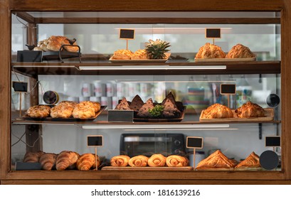 Variety baked bread and dessert in glass showcase at bakery cafe - Powered by Shutterstock