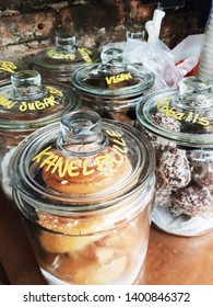 A variety of breakfast treats for sale in a coffee shop in glass canisters