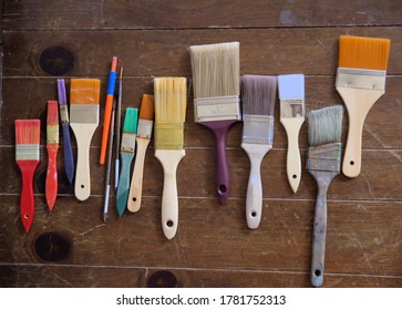 A variety of brushes for use on painting a large canvas.