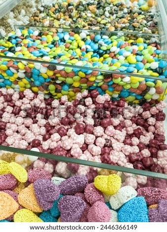 A variety of candy in a display case. Jelly sugar candies. Colorful Sweets on a market, candy shop.
