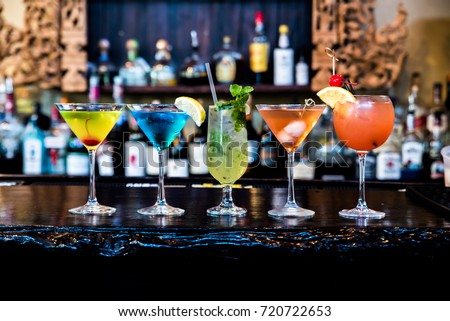 A variety of cocktails are placed on the counter bar in the restaurant.