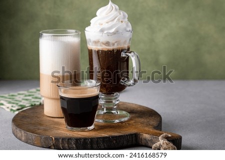 Variety of coffee drinks on green background, Irish coffee and cream liquor latte