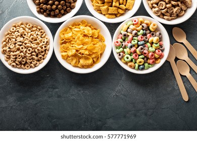 Variety Of Cold Cereals In White Bowls, Quick Breakfast For Kids Overhead Shot With Copyspace