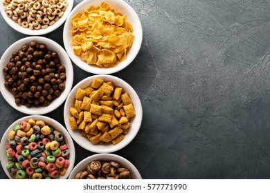 Variety Of Cold Cereals In White Bowls, Quick Breakfast For Kids Overhead Shot With Copyspace