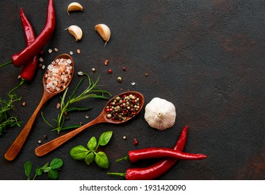 Variety Of Colorful Spices. Salt Flakes, Mixed Pepper, Rosemary, Basil And Garlic On Dark Black Slate Background. Top View. Copy Space.