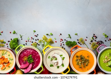 Variety of colorful vegetables cream soups and ingredients for soup. Top view. Concept of healthy eating or vegetarian food.