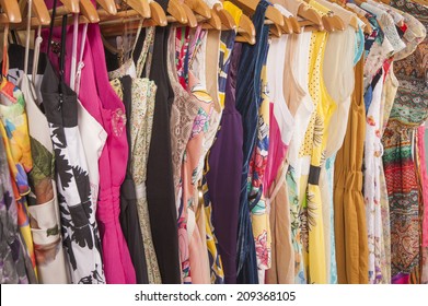 Variety Of Colorful Womens Summer Clothing Hanging On Rail In Fashion Shop