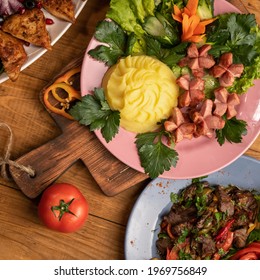 Variety of delicious and healthy dishes. Set lunch. Hearty meals. Top view of assorted meat and vegetables on wooden table. Food concept. Square format or 1x1 for posting on social media.