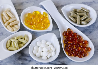  Variety of dietary supplements, including capsules of Garlic, Evening Primrose Oil; Artichoke Leaf;  Olive Leaf; Magnesium and Omega 3 Fish Oil.Selective focus. Taken in daylight. - Shutterstock ID 260690168