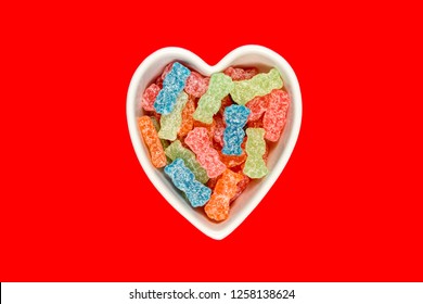 Variety Of Different Color Sweet And Sour Candy Or Sugar Junk Food In A Heart Shaped Bowl.