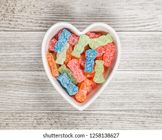 Variety Of Different Color Sweet And Sour Candy Or Sugar Junk Food In A Heart Shaped Bowl.