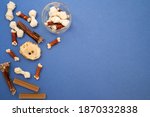 Variety of dog treats. Dod delicacy food on blue background with copy space. flat lay