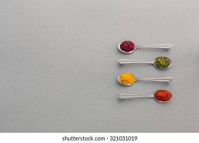 Variety of Eastern Spices in Silver Spoons 
Image of Grey Metal Spoons with Selection of Aromatic Seasonings on Classic Grey Wooden Background - Powered by Shutterstock