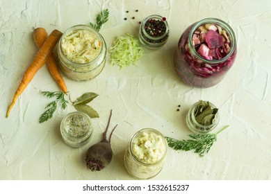 Variety of fermented cabbage in jars carrot beet spice on white background with copy space. Process of pickling