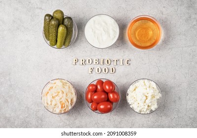 A Variety Of Fermented Foods For Gut Health. Bowls On A Gray Background. Cucumbers, Tomatoes, Sauerkraut, Yogurt, Cottage Cheese, Apple Cider Vinegar.