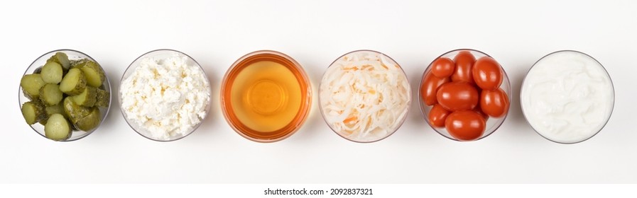 A Variety Of Fermented Foods For Gut Health. Bowls On A White Background. Cucumbers, Tomatoes, Sauerkraut, Yogurt, Cottage Cheese, Apple Cider Vinegar. Banner.