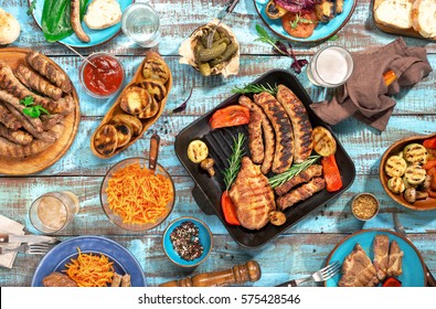 Variety Of Food Grilled On Wooden Table, Top View. Outdoors Food Concept