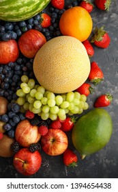 Variety Of Fresh Fruits And Berries On Dark Background: Cantaloupe, Melon, Watermelon, Blueberry, Oranges, Apple, Strawberry, Pineapple, Mango, Grapes And Kiwi.