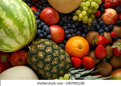 Variety Of Fresh Fruits And Berries On Dark Background: Cantaloupe, Melon, Watermelon, Blueberry, Oranges, Apple, Strawberry, Pineapple, Mango, Grapes And Kiwi.