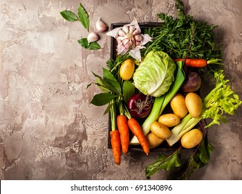 Variety Of Fresh Raw Vegetable Ingredients For Cooking Of Vegetable Soup Or Stew. Autumn Vegetable Still Life On Rustic Vintage Background. Top View