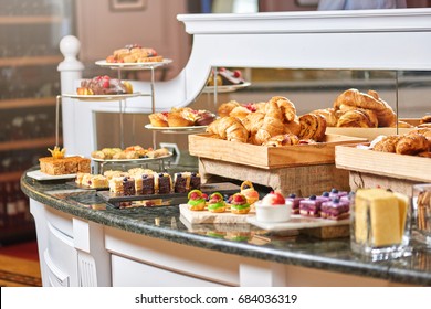 A variety of freshly made pastry in the sunlight, luxury hotel breakfast buffet isolated, restaurant interior