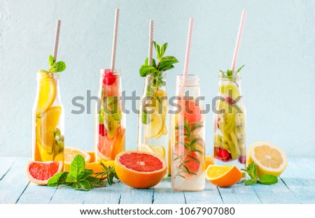 Similar – Infused water in bottles with drink straw and ingredients on white background, front view. Water Flavored with fruits, berries and herbs. Summer drinks. Healthy and clean detox beverages.