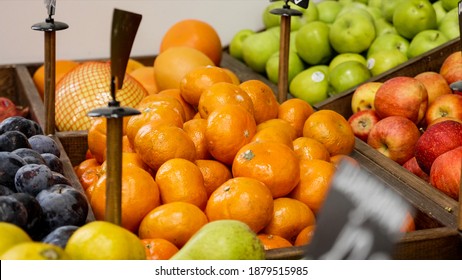 Variety Fruits On Store Shelves - Mandarines, Plums, Apples, Pears. Grocery Department Of Supermarket, No People.