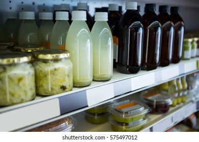 Variety of healthy juices and jars of sauerkraut on display shelf in supermarket - Powered by Shutterstock