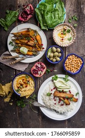 Variety Of Healthy Vegan Snacks, Gourmet Dips. Hummus,  Roasted Carrots, Rice With Tempeh In Ceramic Bowls Viewed From Above, Plant Based Food