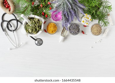 Variety of herbs and herbal mixtures as an alternative medicine concept on wooden table background top view. Homeopathy treatment.