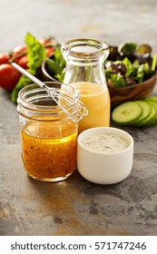 Variety Of Homemade Sauces And Salad Dressings In Jars Including Vinaigrette, Ranch And Honey Mustard