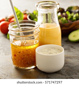 Variety Of Homemade Sauces And Salad Dressings In Jars Including Vinaigrette, Ranch And Honey Mustard