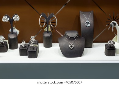 Variety of jewelry in store window. rings, bracelets, earrings and necklaces on stands for sale - Powered by Shutterstock